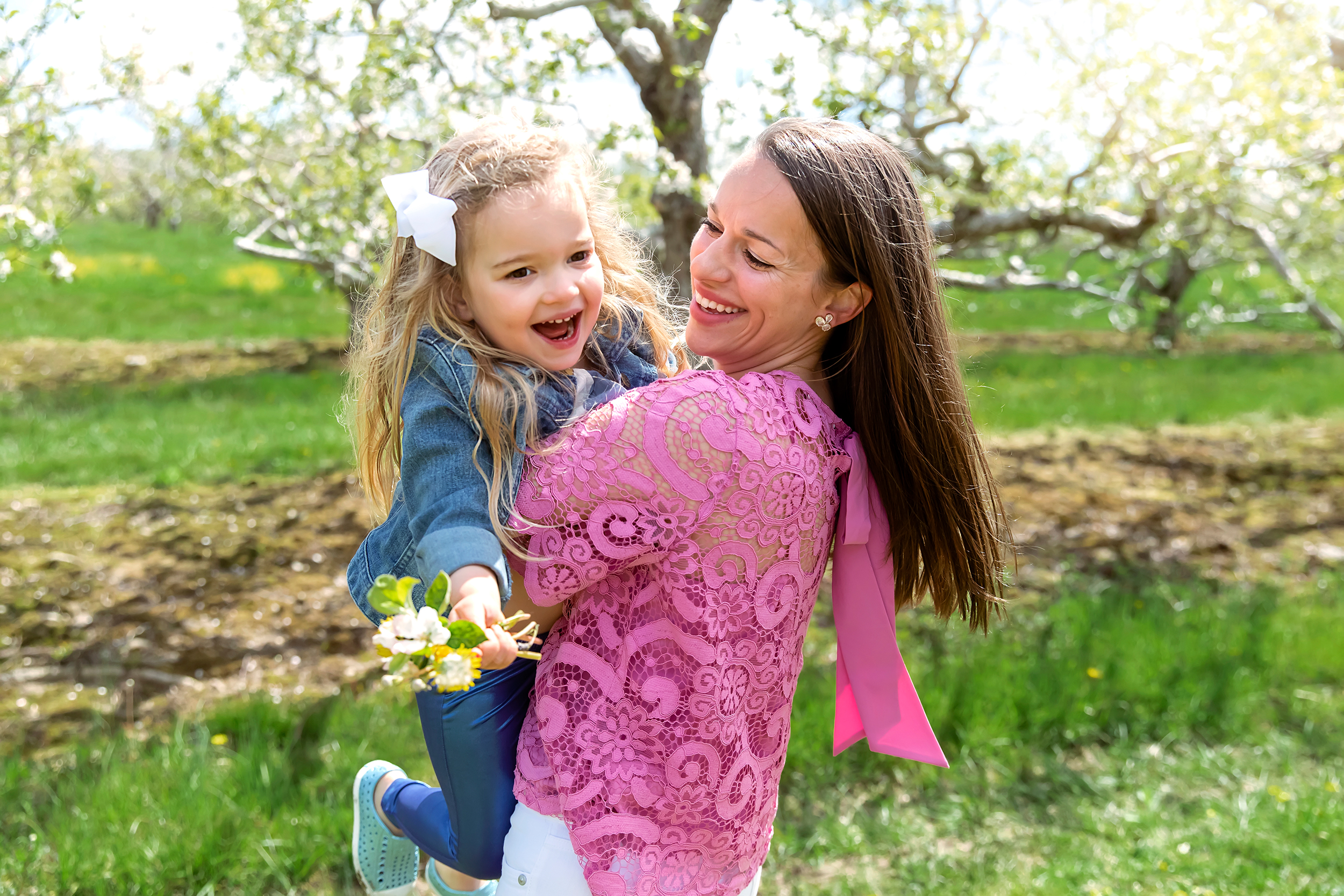 mom in pink shirt spinning her daughter around, CT Family photographer