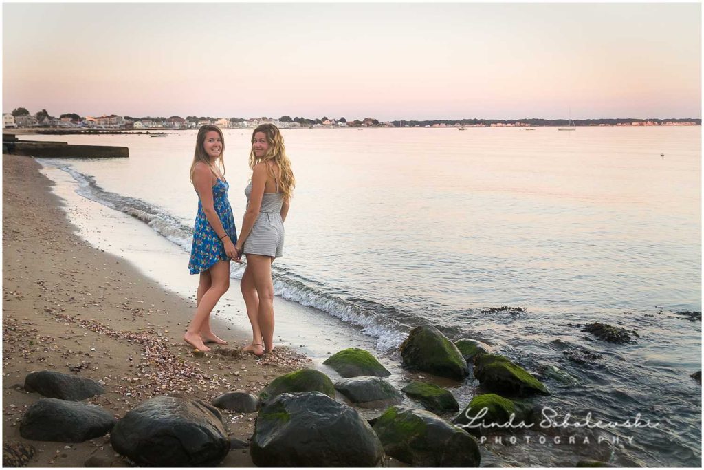 two girls on the beach at sunset