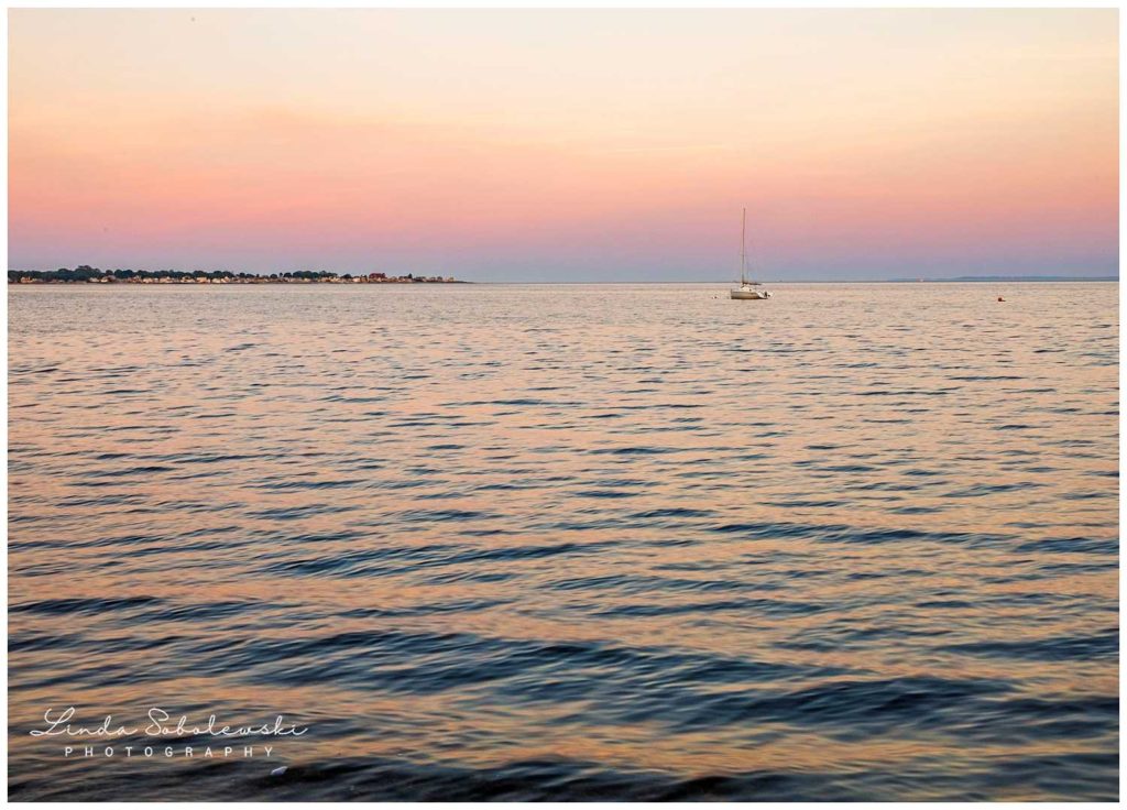 beautiful pink skies as the sun is setting over the water, westbrook, ct photographer