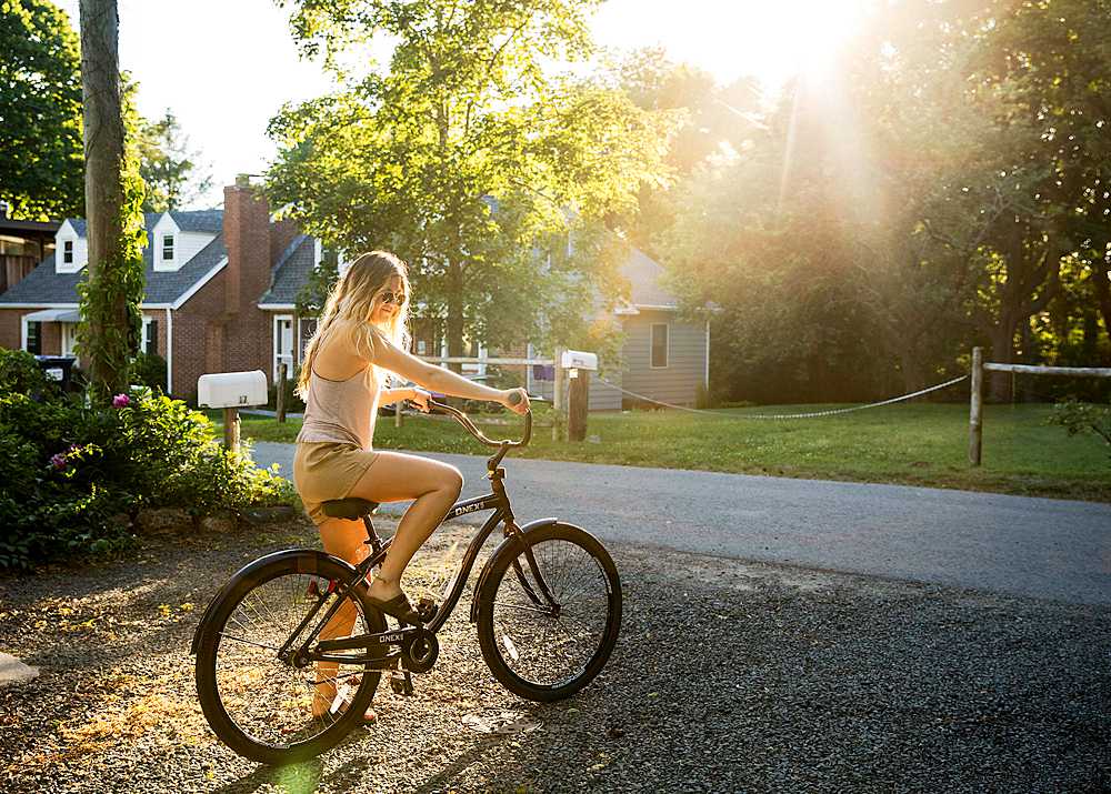 girl riding bike in the summer sun, connecticut shoreline photographer