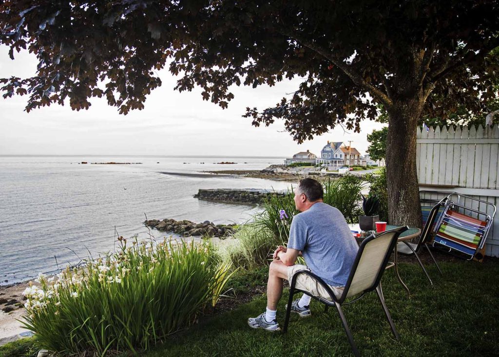 man sitting in a chair overlooking the water, Westbrook lifestyle photographer