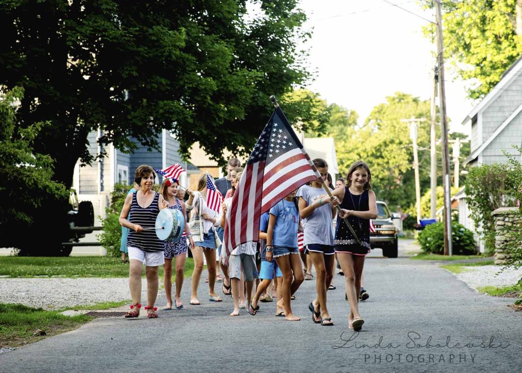 children marching down the street in a 4th of July parade, Westbrook family photographer, 