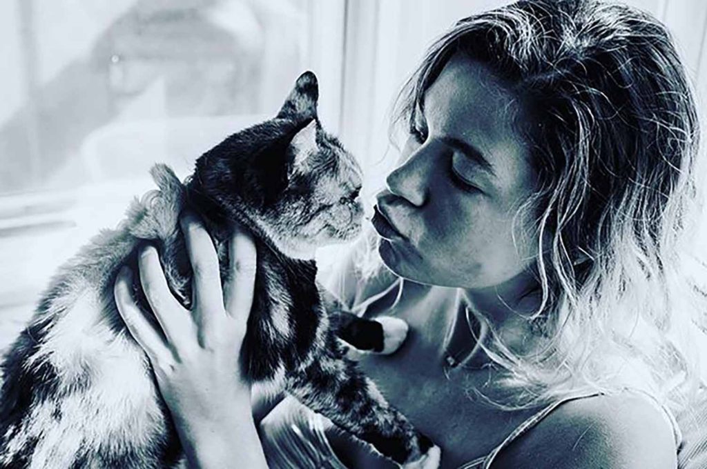 black and white image of girl holding cat