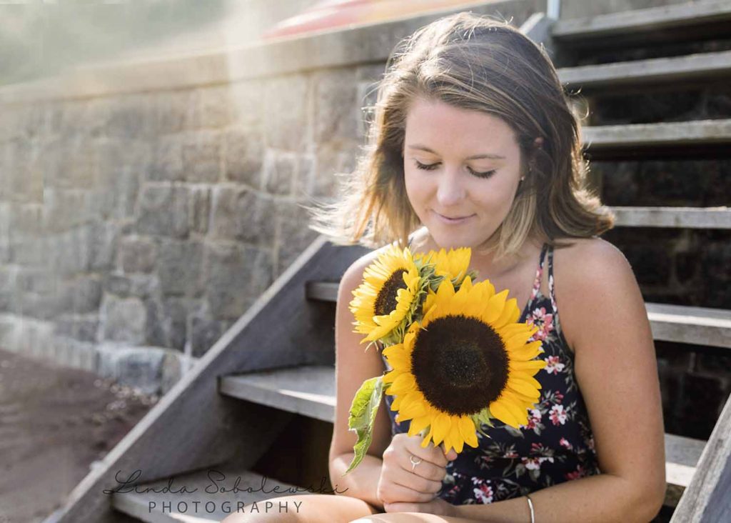 girl holding a sunflower, summer comes to an end, Westbrook portrait photographer