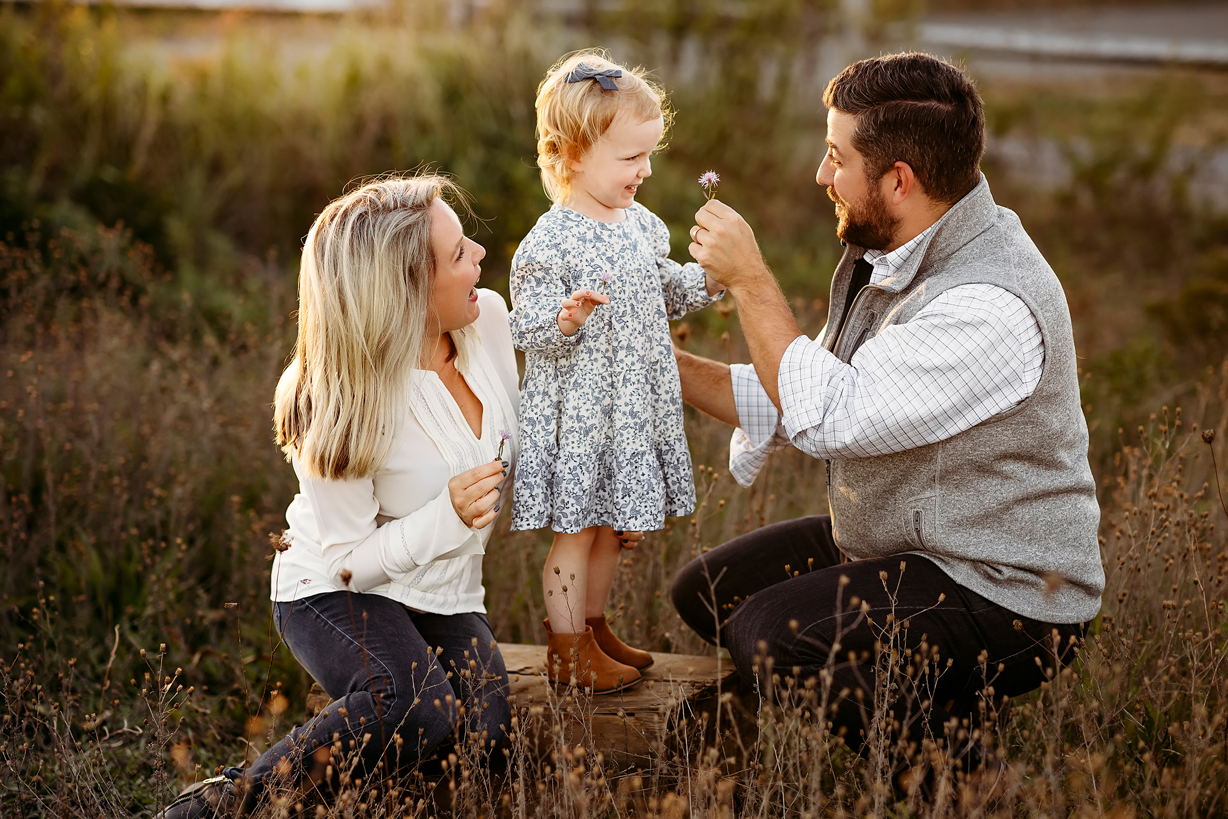 mom and dad giving their little girl a flower, CT Family Photographer, Tips to Look Your Best
