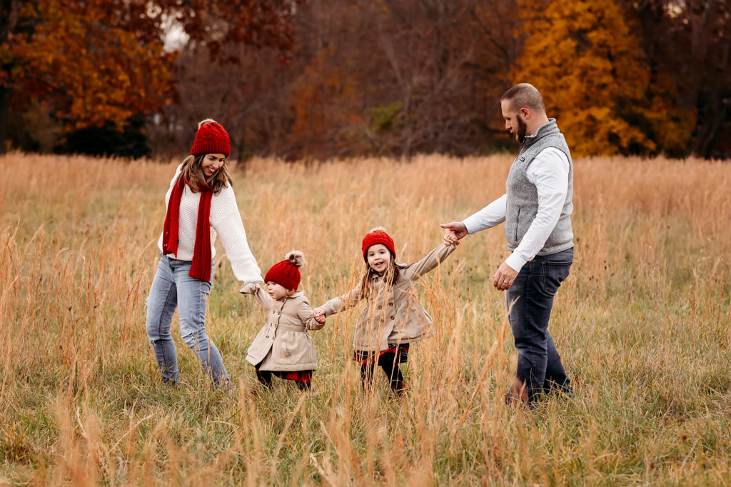 family of four walking in the grass, What To wear to a tree farm session, CT shoreline photographer