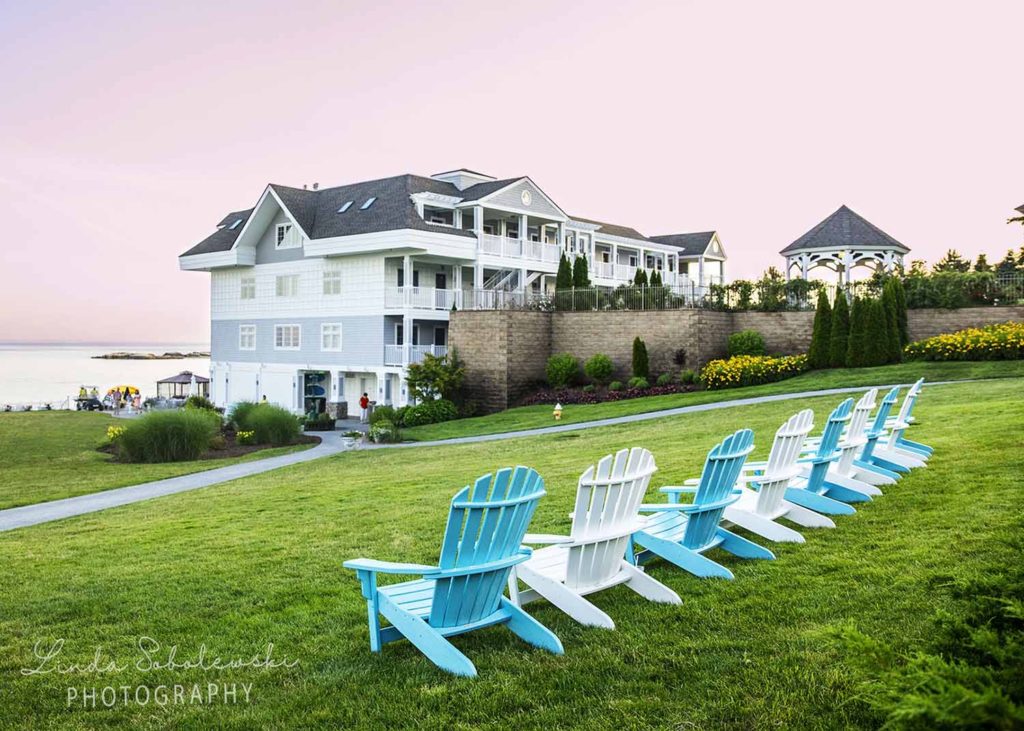row of blue and white Adirondack chairs at the waters edge, Westbrook Connecticut photographer