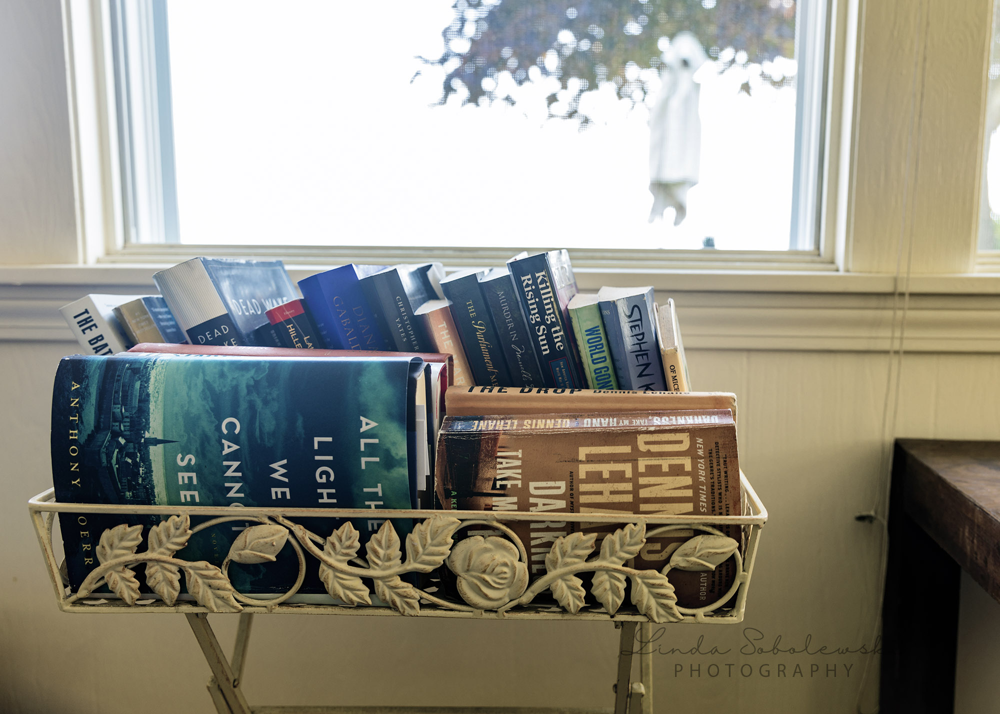 stack of books by a window, Westbrook ct lifestyle photographer