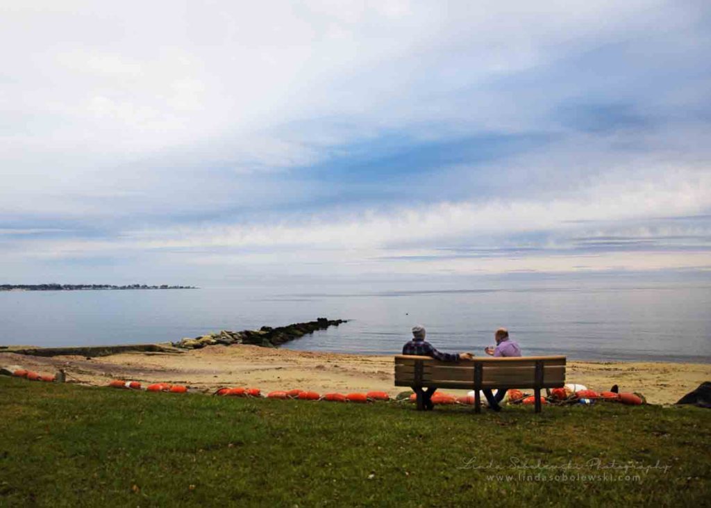 people sitting on a bench at the beach, Westbrook ct photographer