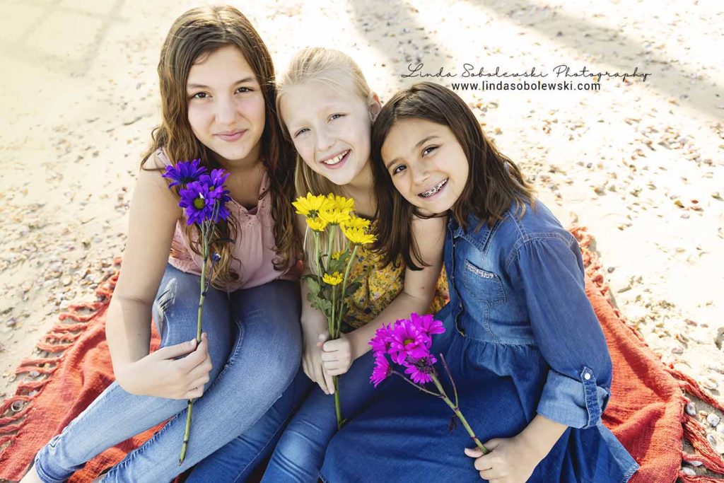 three girls sitting on a blanket at the beach, chapman beach Westbrook ct photographer