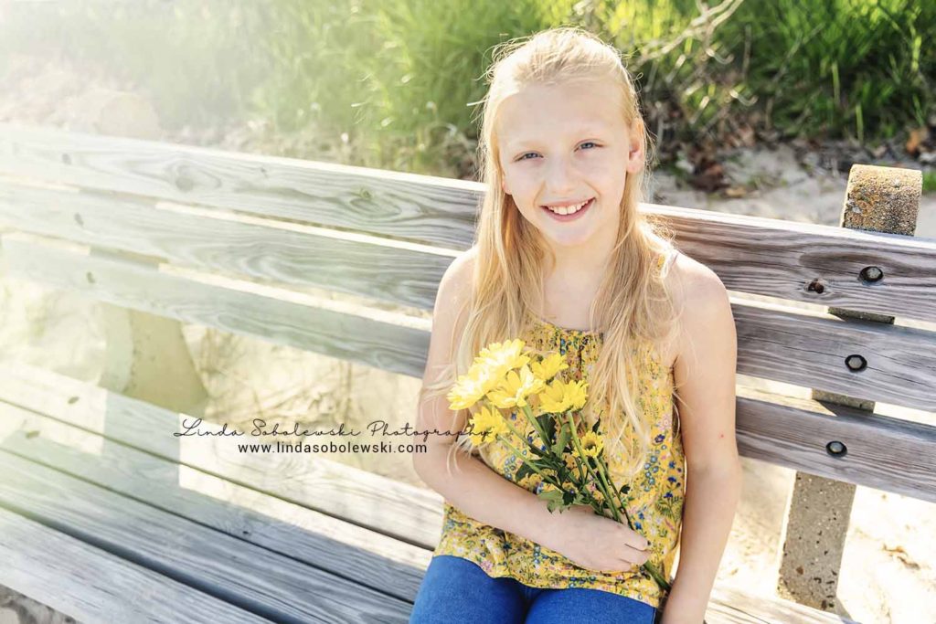 girl with long blonde hair holding flowers, Westbrook family photographer