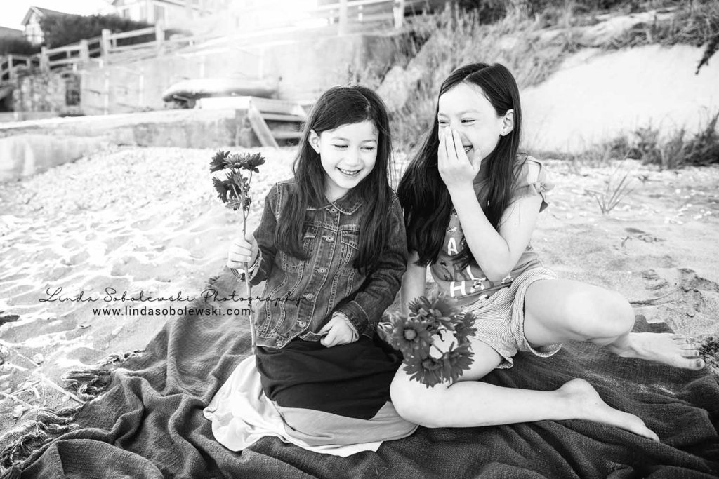 black and white image of two little girls sitting the beach, westbrook ct family session