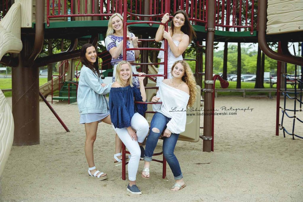 five girls playing on the playground at the Madison surf club, westbrook Connecticut senior photographer