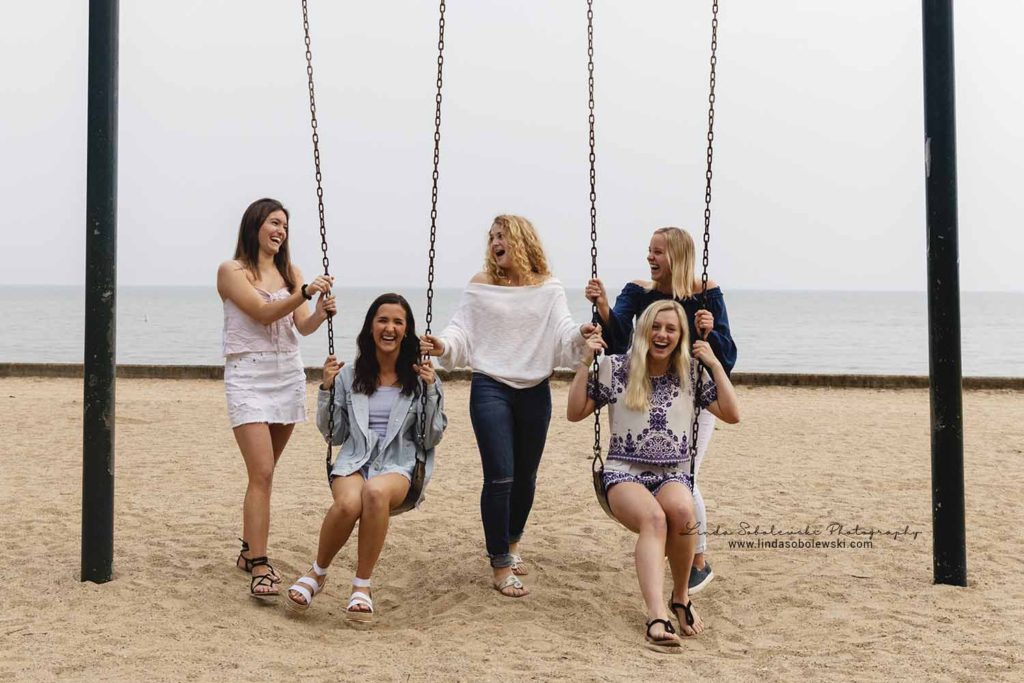 five senior girls playing on the swings at the Madison surf club, Connecticut senior photographer