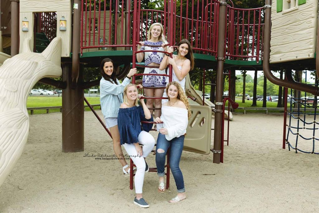 five senior girls on the playground at the Madison surf club, westbrook senior photographer