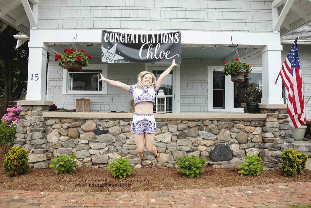 senior girl with blonde hair jumping in the air, Madison ct senior photographer