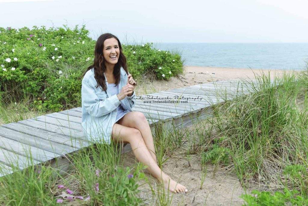 girl with dark hair laughing at the beach, Madison senior photographer