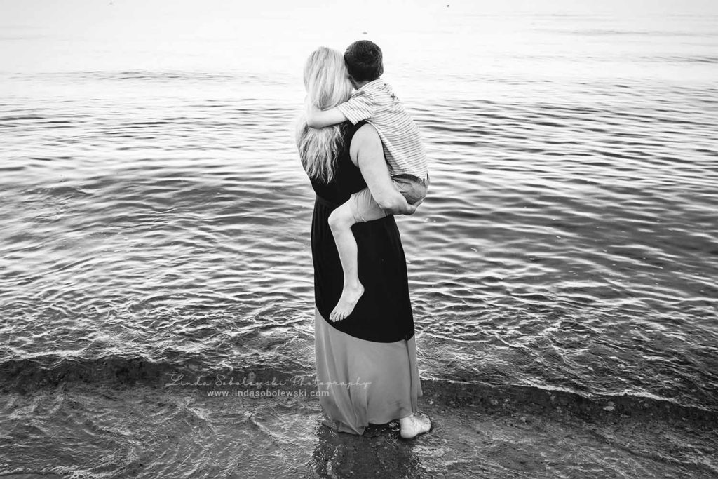 black and white image of mother and son at the beach, old Saybrook ct photographer