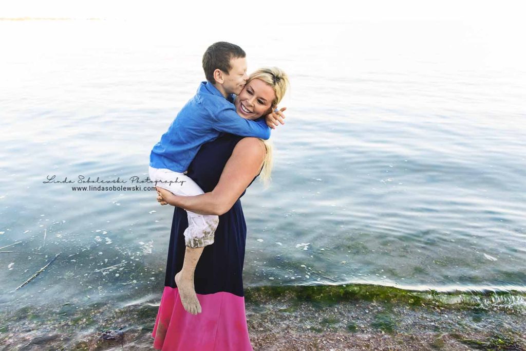 little boy kissing his mom at the beach, Connecticut shoreline family photographer