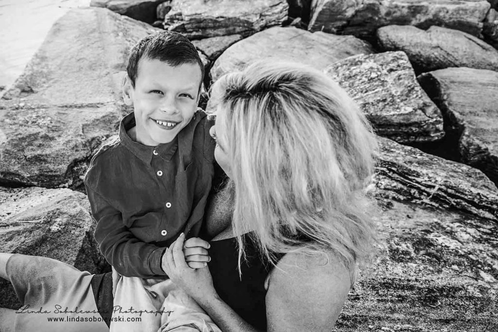 black and white image of mother and son at the beach, westbook ct family photographer