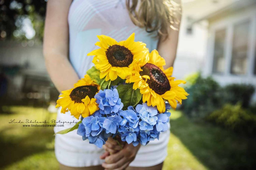 girl holding yellow sunflowers and blue hydrangea flowers, project 52, color theory
