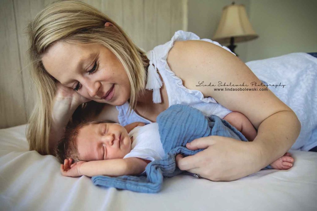 mom loving her new baby boy, guilford new family of four photo session