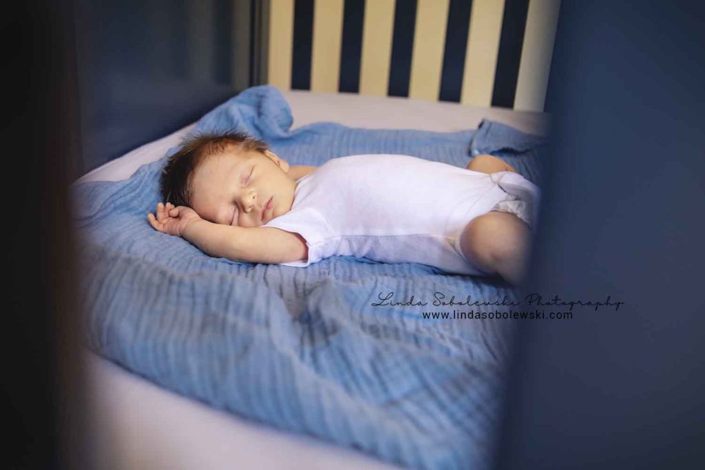 newborn baby boy in crib, guilford new family of four photo session