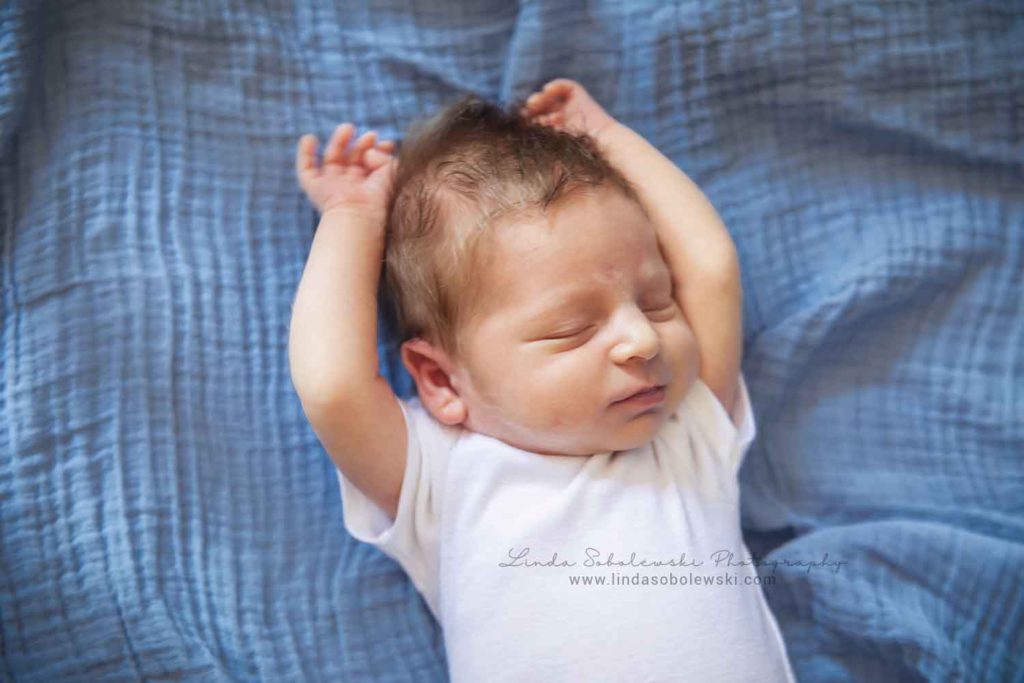 newborn baby boy in crib, guilford new family of four photo session