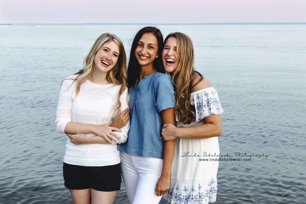 three sisters laughing at the beach, family photo session at water's edge, westbrook lifestyle photographer