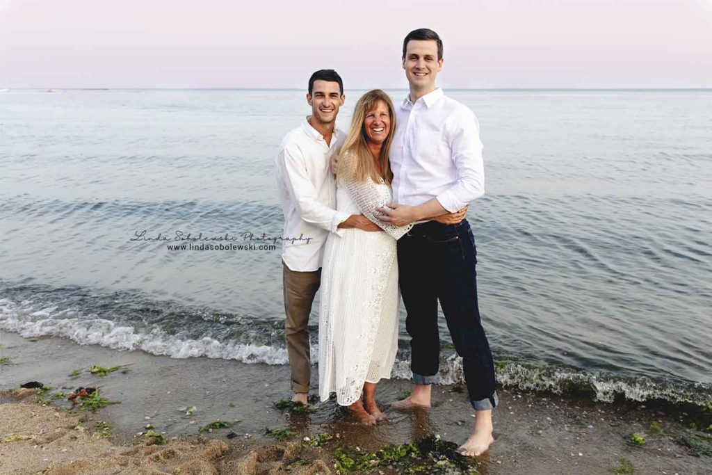 mom and her two adult sons at the beach, family photo session at water's edge, westbrook ct family photographer