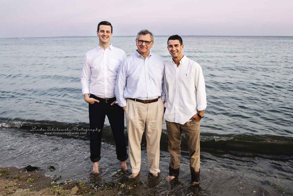 father and his two sons at the beach at water's edge, family photo session