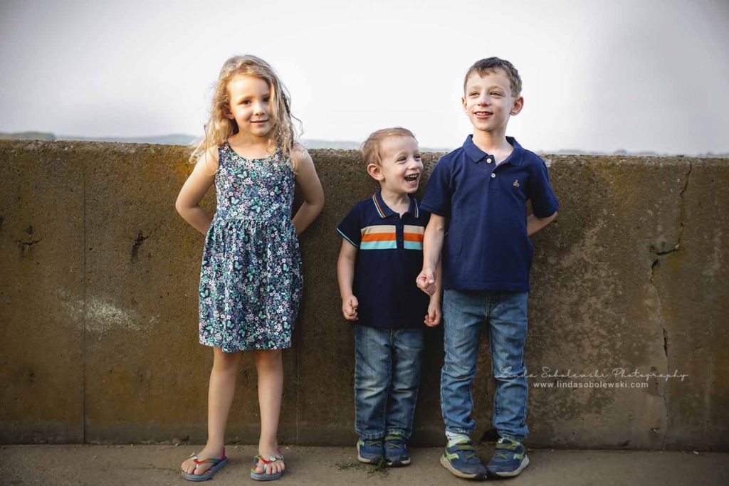 three children standing at a cement wall, old Saybrook family photo session, westbrook ct lifestyle photographer