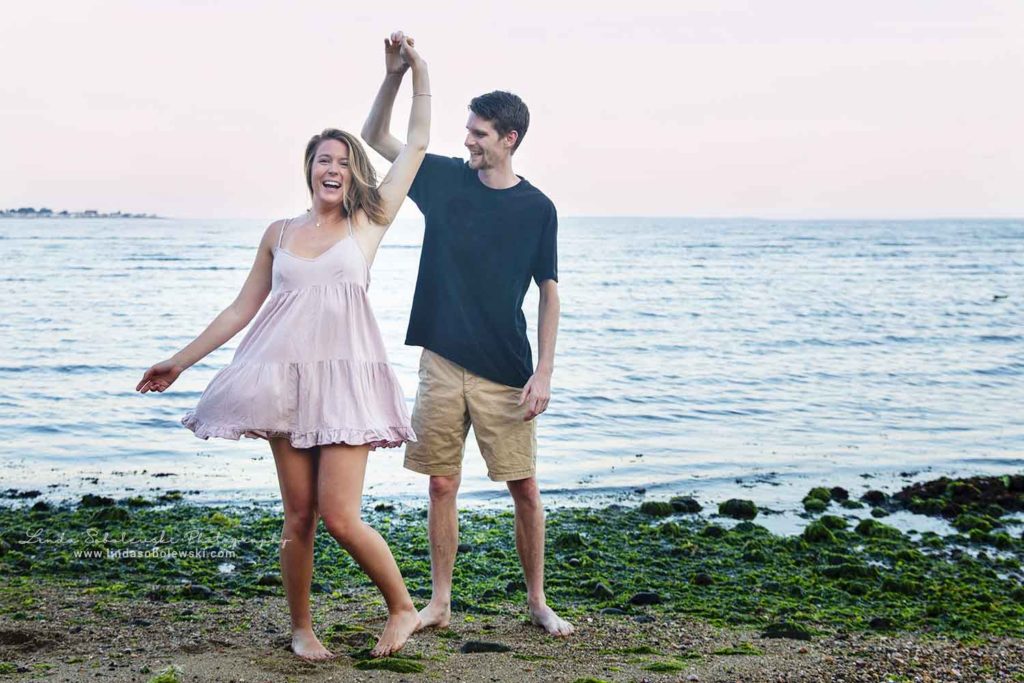 girl in pink dress being spinned around by her boyfriend, chapman beach, august 2019, westbrook ct photographer