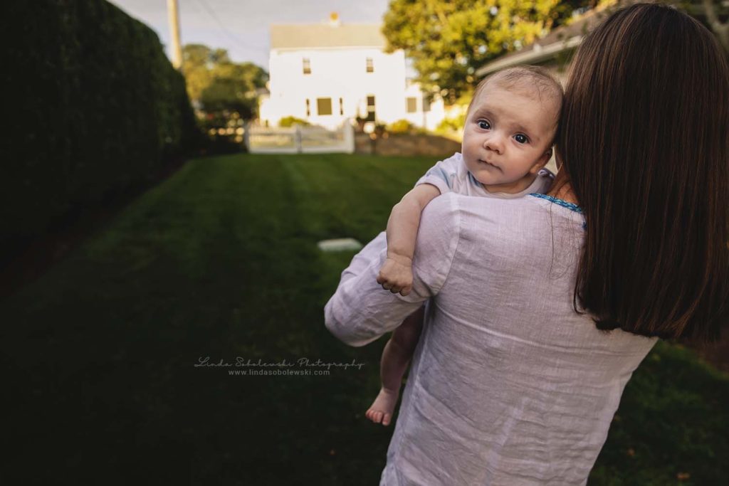 alert baby boy being held by his mom, extended family portraits, old Saybrook ct photographer