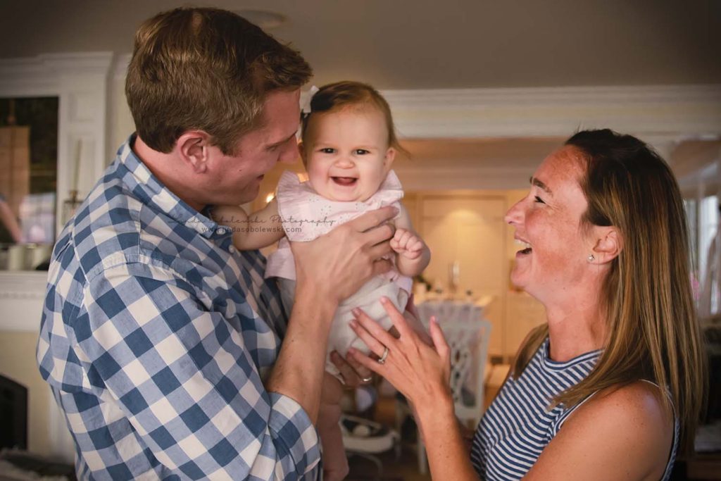 mom and dad laughing with their baby girl, connecticut lifestyle photographer