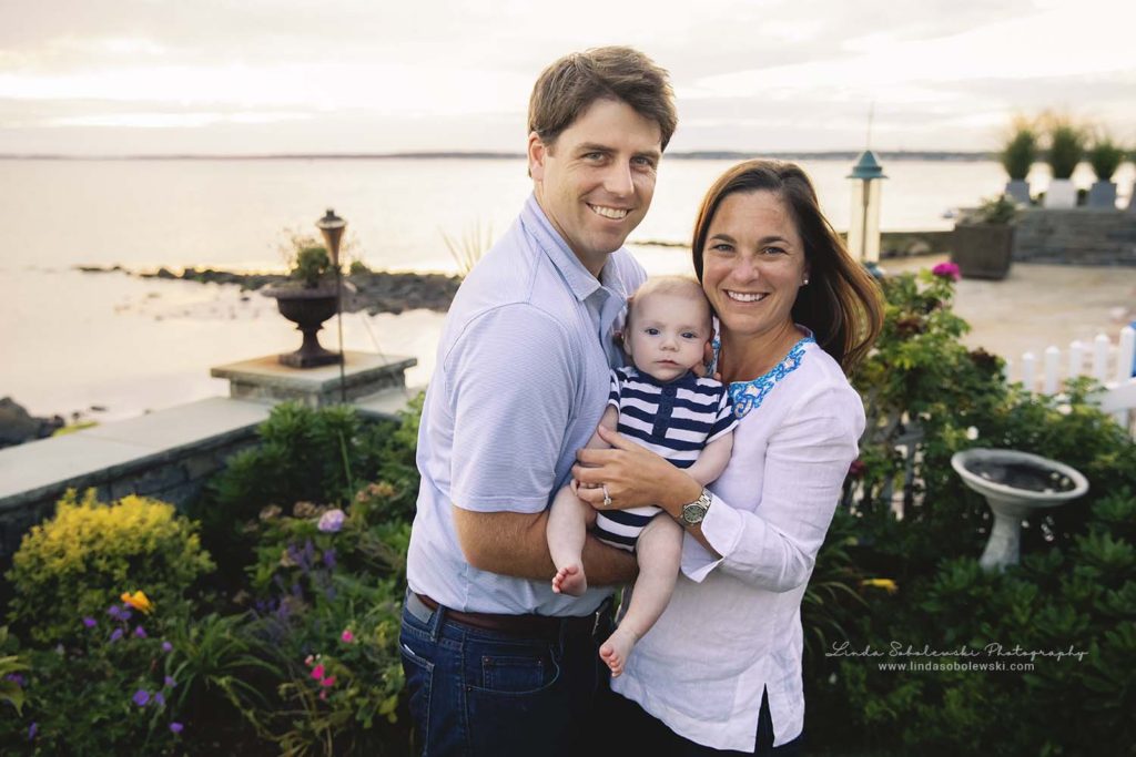 mom and dad holding their baby at the beach, extended family portraits in old Saybrook, ct photography session