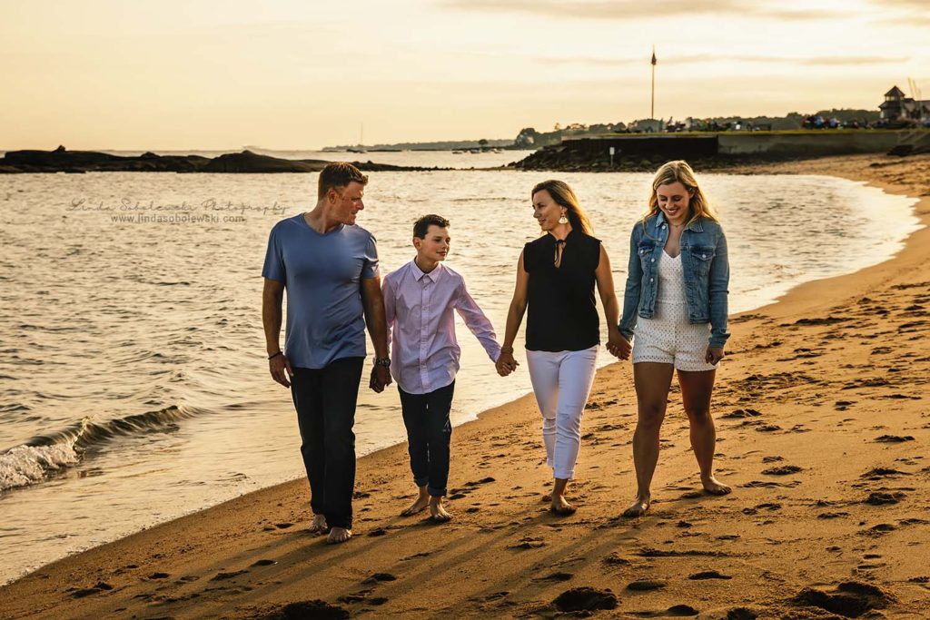 family walking holding hands at the madison surf club, connecticut family photographer