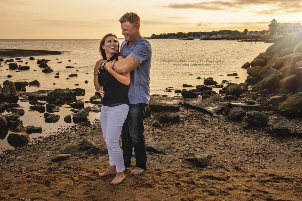 husband and wife at the beach in madison, ct. family photo session