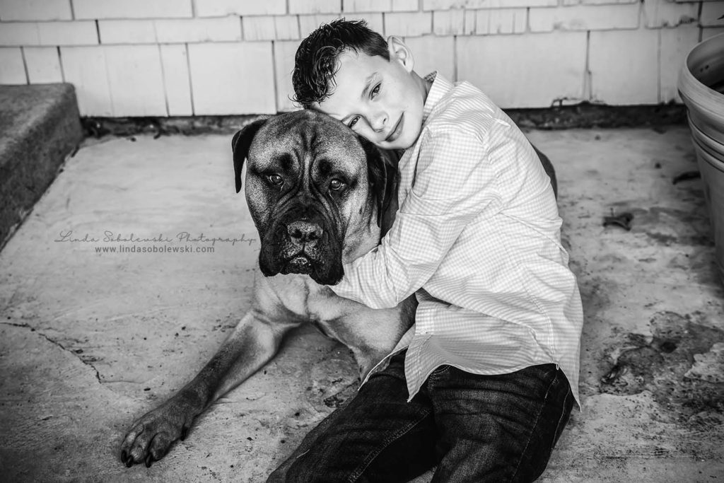 a black and white image of a boy and his dog, madison, ct family photographer