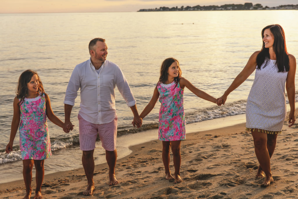 family of four walking on the beach together, westbrook family photographer