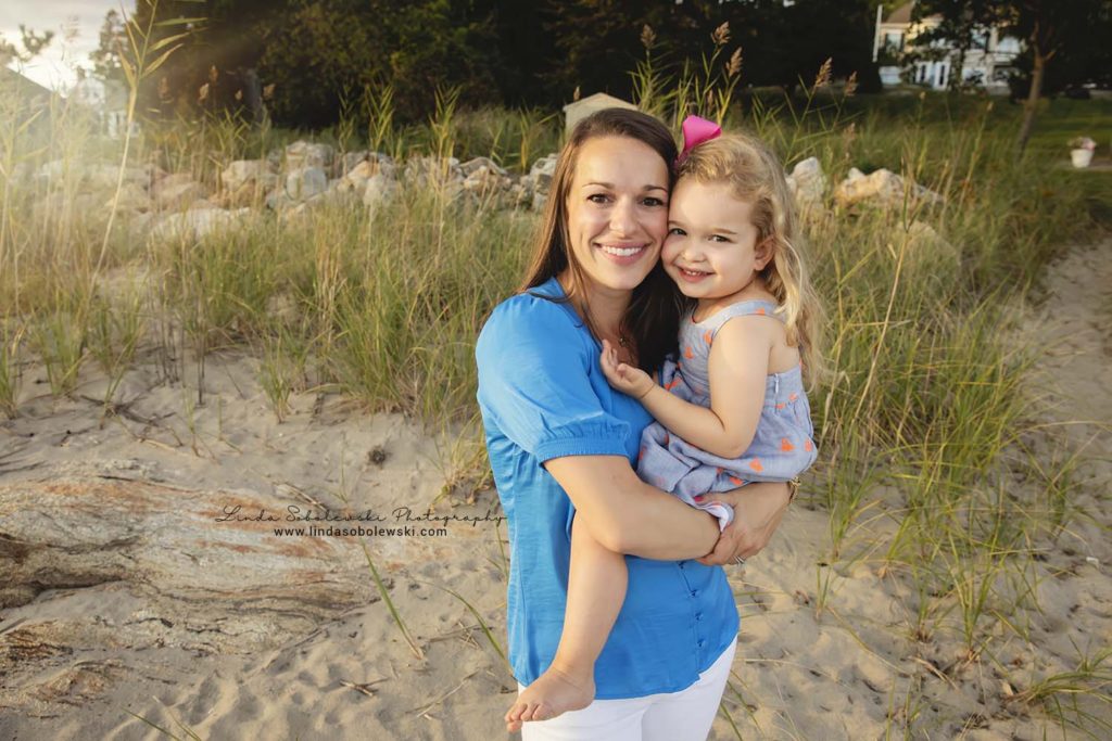 mom holding her little blonde girl on the beach, Old Saybrook CT family photographer