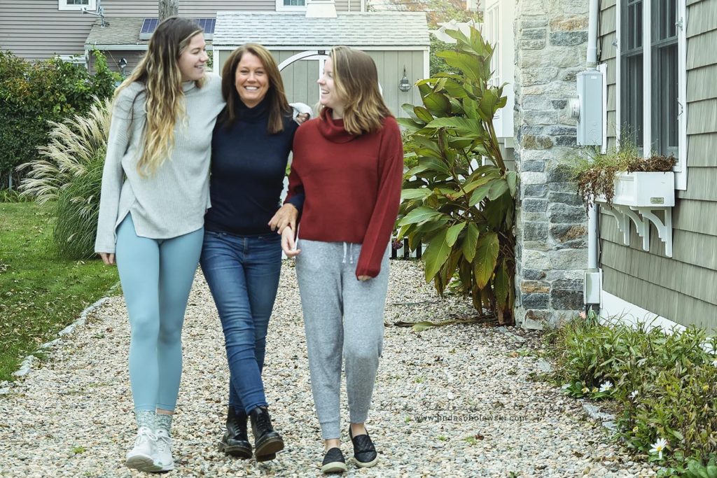 mother and her daughters walking together, Connecticut shoreline lifestyle photographer
