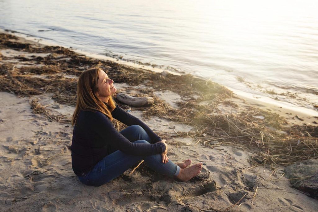 woman sitting on a beach, october 2019 personal project - self portait, old saybrook, CT photographer