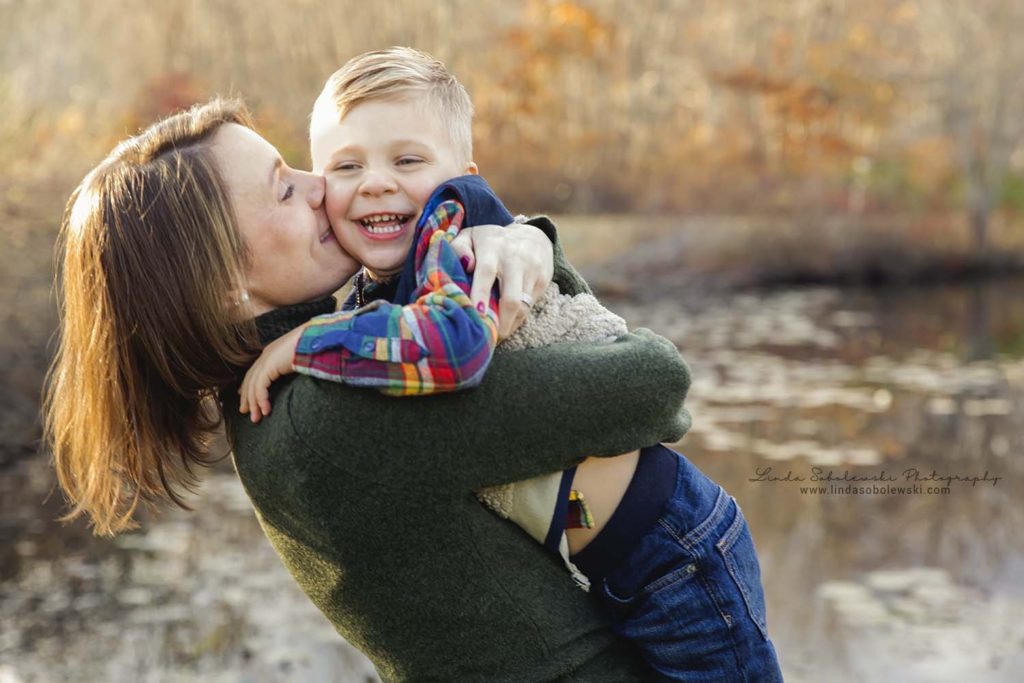 mom kissing her young son, fall family photo session at Bauer park, Madison, CT photographer