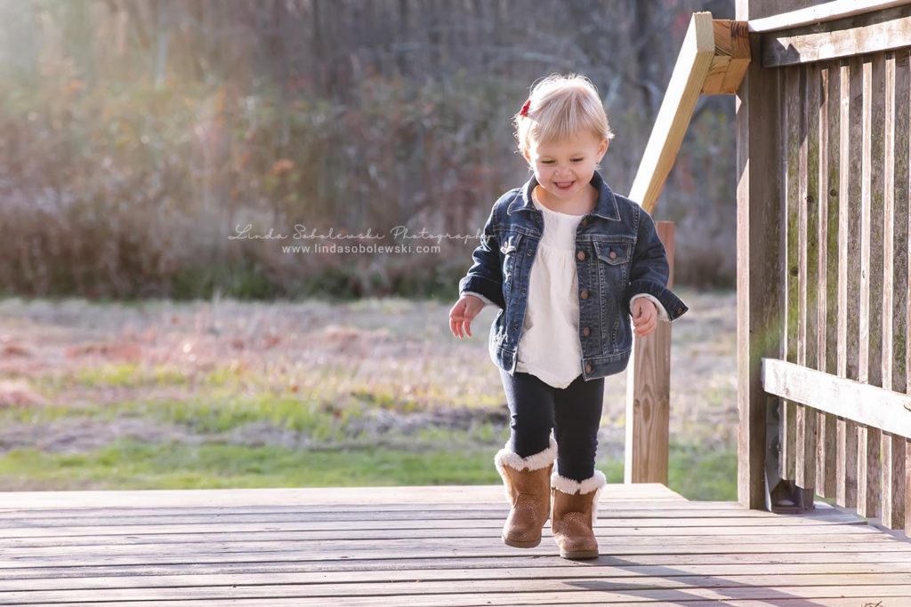little blonde girl running on a covered bridge, Bauer Park Family Photo Session, Madison, CT photography
