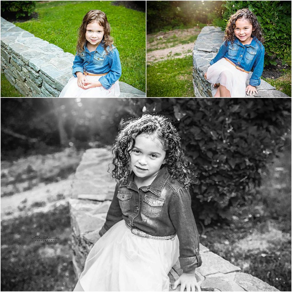 adorable little girls with pink tulle skirts sitting on a stone wall at their home, Family of Five Photo Shoot, Connecticut Lifestyle Photographer