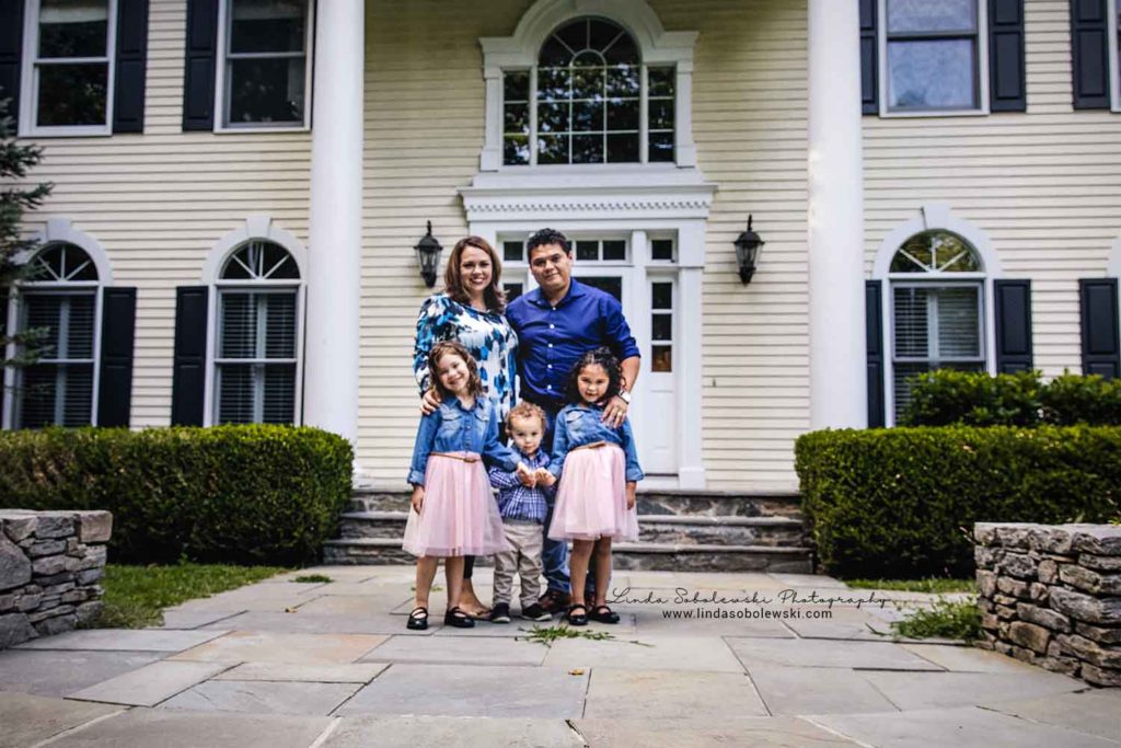 Family of five posing on the front steps of their home, Guilford Photographer
