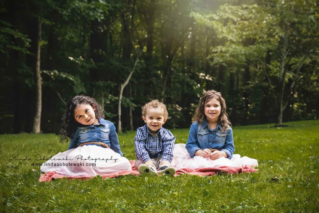 three children sitting on the grass, Family of Five photo session, Guilford, CT Photographer