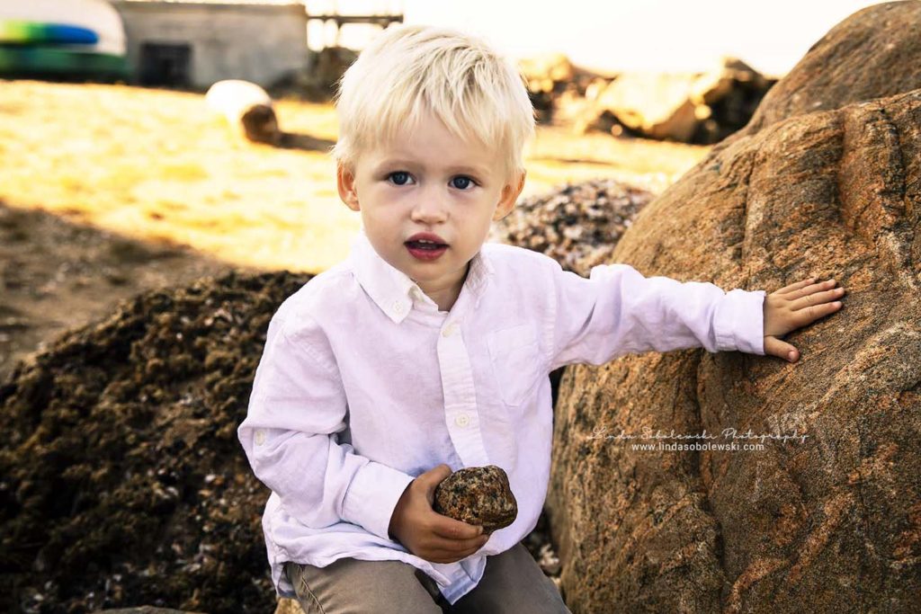 little blonde boy sitting on a rock, Connecticut Shoreline Child Photographer