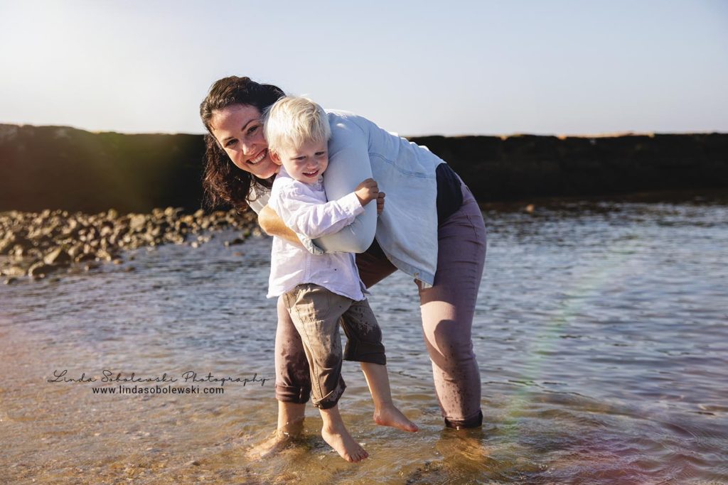aunt spinning her blonde nephew at the beach, Connecticut Family Photographer